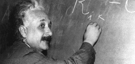 Albert Einstein (1879-1955) who developed the theory of relativity on a blackboard